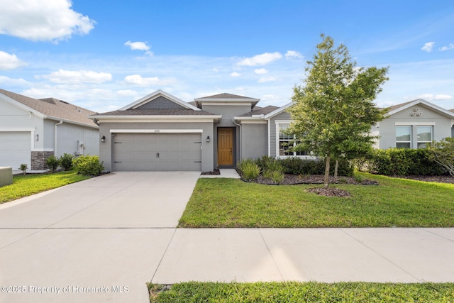 1098 Old Windsor Way, Spring Hill, FL 34609 - view of front of home featuring a garage, stucco siding, driveway, and a front lawn