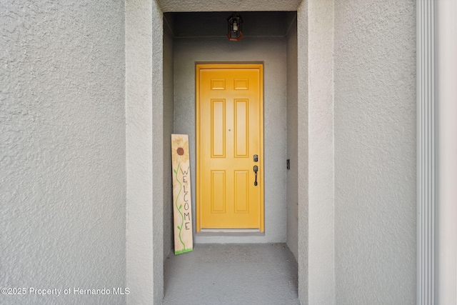 1098 Old Windsor Way, Spring Hill, FL 34609 - view of exterior entry featuring stucco siding