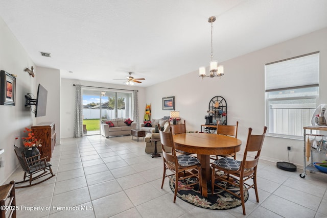 1098 Old Windsor Way, Spring Hill, FL 34609 - dining area with ceiling fan, light tile patterned flooring, and a chandelier