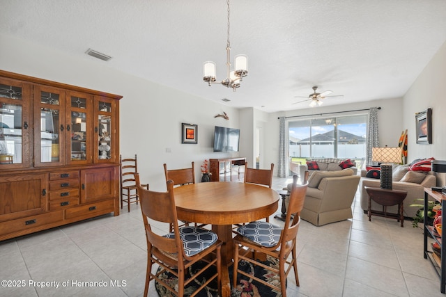 1098 Old Windsor Way, Spring Hill, FL 34609 - dining room with light tile patterned floors, a ceiling fan, a chandelier, and a textured ceiling