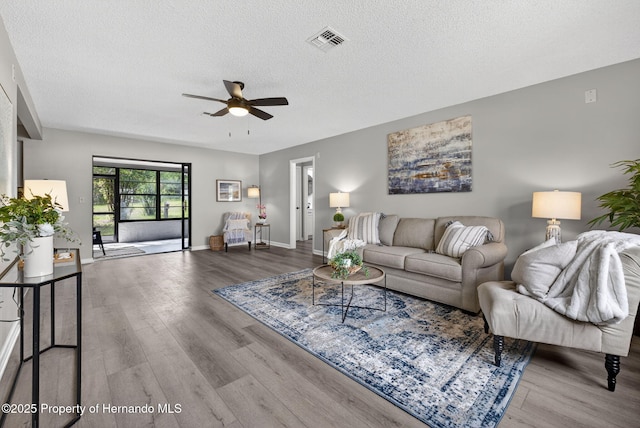 6310 Gainsboro Ave, Spring Hill, FL 34609 - living room with a ceiling fan, wood finished floors, and a textured ceiling