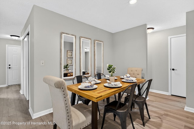 6310 Gainsboro Ave, Spring Hill, FL 34609 - dining room with baseboards and light wood-type flooring