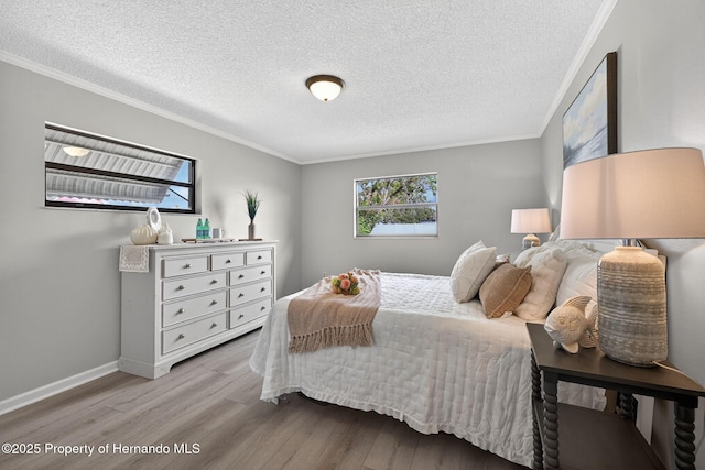 6310 Gainsboro Ave, Spring Hill, FL 34609 - bedroom featuring wood finished floors, crown molding, and a textured ceiling