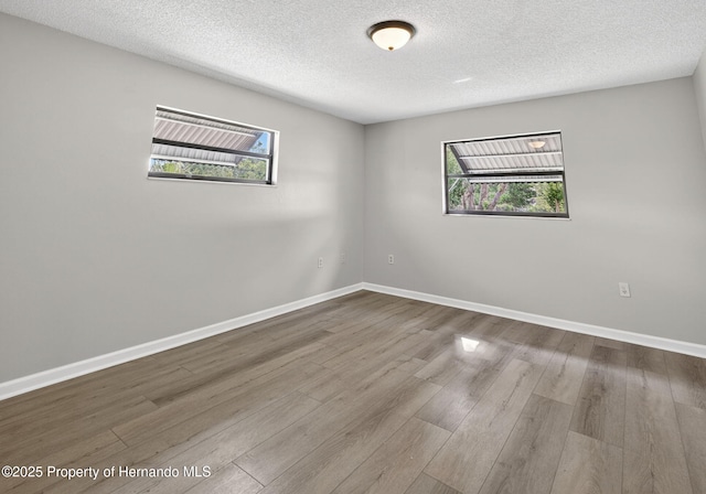 6310 Gainsboro Ave, Spring Hill, FL 34609 - unfurnished room with wood finished floors and a textured ceiling