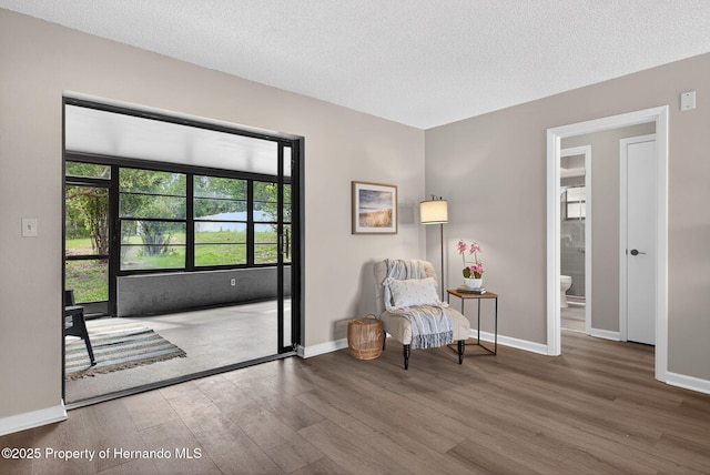 6310 Gainsboro Ave, Spring Hill, FL 34609 - sitting room with wood finished floors and a textured ceiling