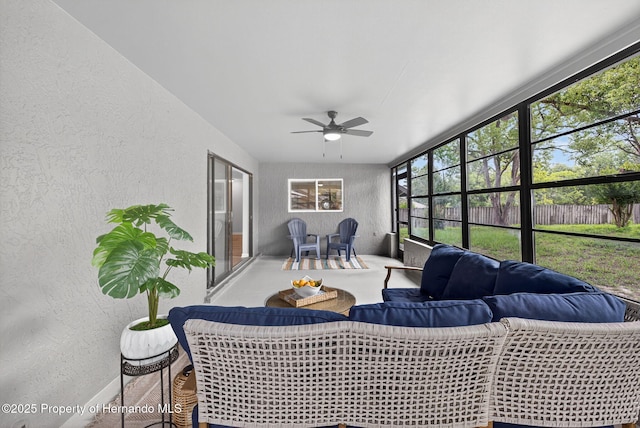 6310 Gainsboro Ave, Spring Hill, FL 34609 - sunroom featuring a ceiling fan, a textured wall, healthy amount of natural light, and an outdoor hangout area
