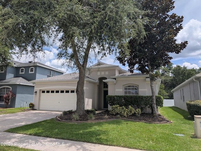 109 Fairmont Dr, Spring Hill, FL 34609 - mediterranean / spanish home with a garage, stucco siding, a front yard, and concrete driveway