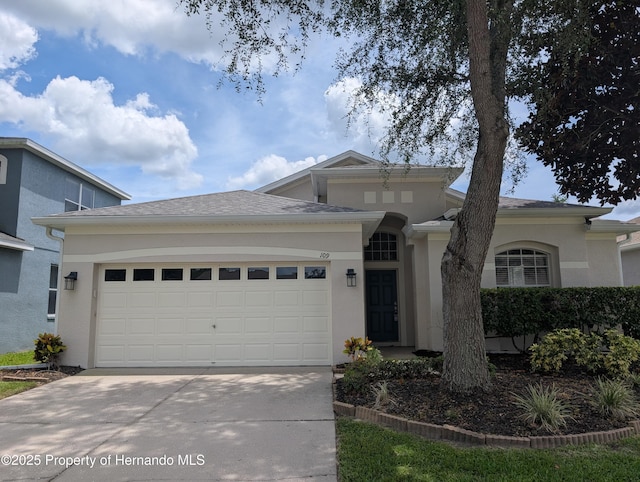 109 Fairmont Dr, Spring Hill, FL 34609 - prairie-style home with driveway, stucco siding, and a garage
