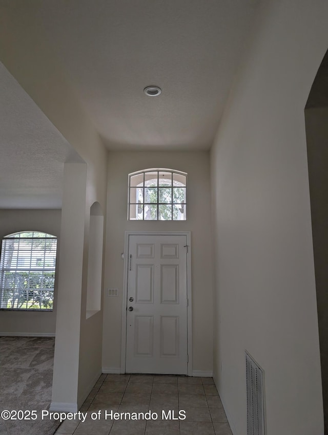 109 Fairmont Dr, Spring Hill, FL 34609 - tiled foyer entrance featuring plenty of natural light and arched walkways