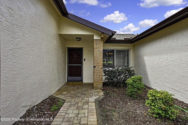 7385 Crestwood Dr, Weeki Wachee, FL 34613 - view of exterior entry with stucco siding