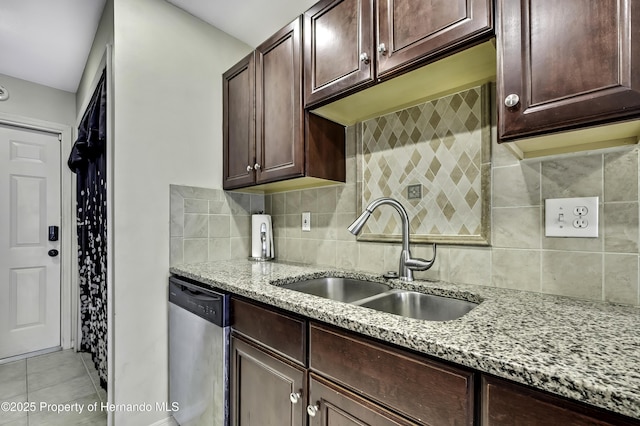 7385 Crestwood Dr, Weeki Wachee, FL 34613 - kitchen featuring stainless steel dishwasher, light stone countertops, tasteful backsplash, light tile patterned floors, and dark brown cabinets
