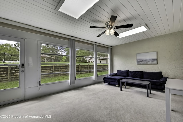 7385 Crestwood Dr, Weeki Wachee, FL 34613 - living room featuring a skylight, a textured wall, carpet floors, ceiling fan, and wooden ceiling