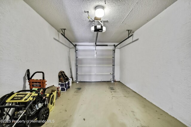 7385 Crestwood Dr, Weeki Wachee, FL 34613 - garage featuring a garage door opener