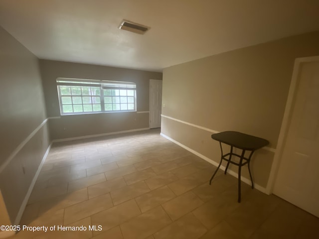 1392 Piper Rd, Spring Hill, FL 34606 - spare room featuring tile patterned floors and baseboards