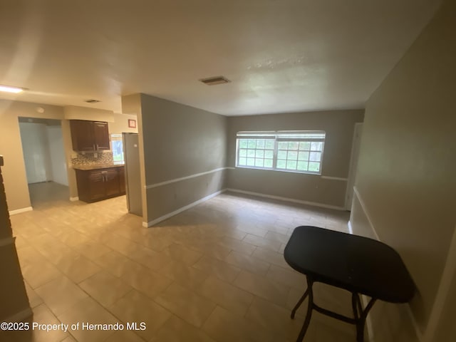 1392 Piper Rd, Spring Hill, FL 34606 - spare room with baseboards and light tile patterned floors