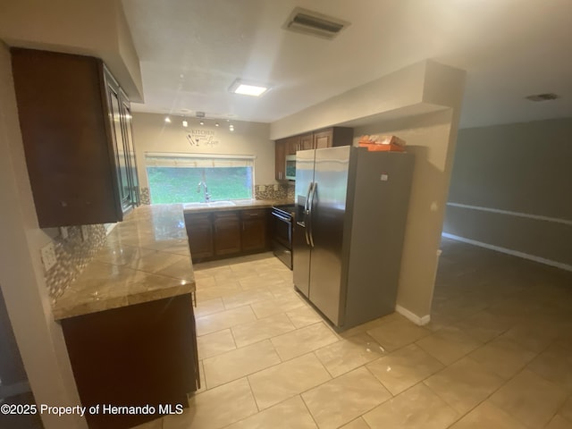 1392 Piper Rd, Spring Hill, FL 34606 - kitchen featuring stainless steel appliances, decorative backsplash, and light tile patterned floors