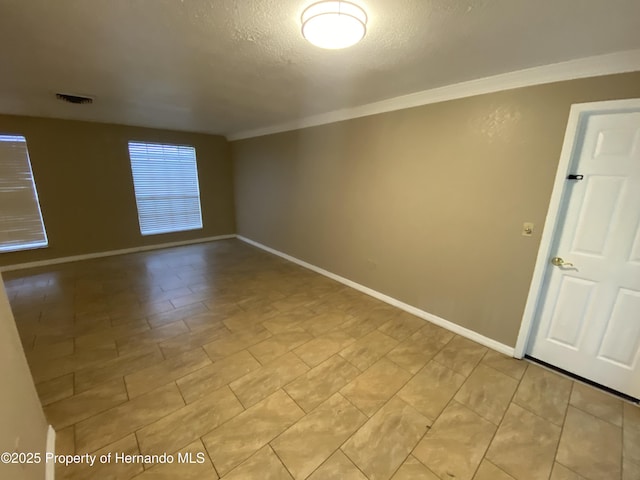 1392 Piper Rd, Spring Hill, FL 34606 - empty room featuring crown molding and a textured ceiling
