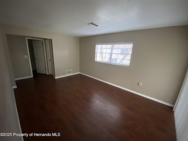 1392 Piper Rd, Spring Hill, FL 34606 - unfurnished room with dark wood-type flooring and baseboards
