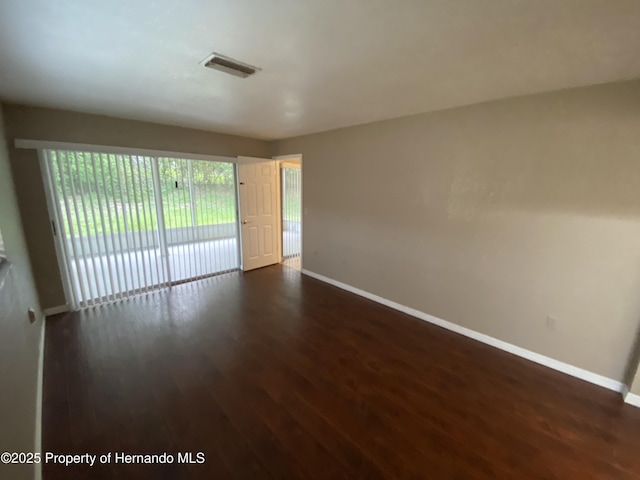 1392 Piper Rd, Spring Hill, FL 34606 - unfurnished room featuring baseboards and dark wood-style floors
