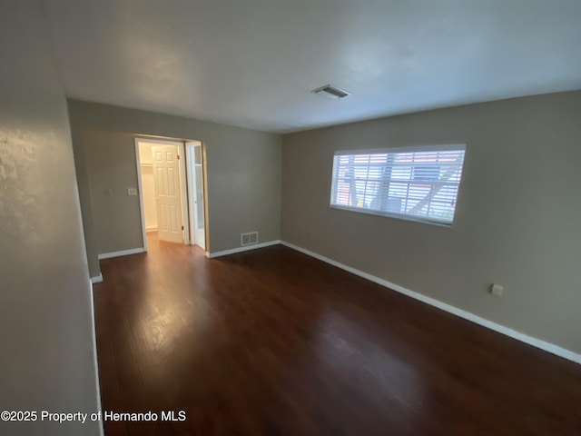 1392 Piper Rd, Spring Hill, FL 34606 - empty room featuring dark wood-style floors and baseboards