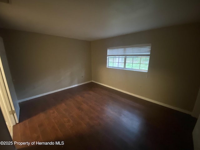 1392 Piper Rd, Spring Hill, FL 34606 - empty room featuring dark wood-style floors and baseboards