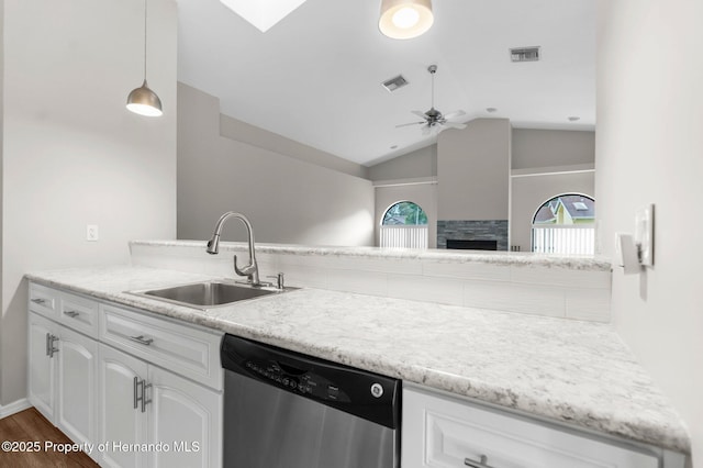 13125 Jessica Dr, Spring Hill, FL 34609 - kitchen with stainless steel dishwasher, a ceiling fan, lofted ceiling, white cabinets, and dark wood-style floors