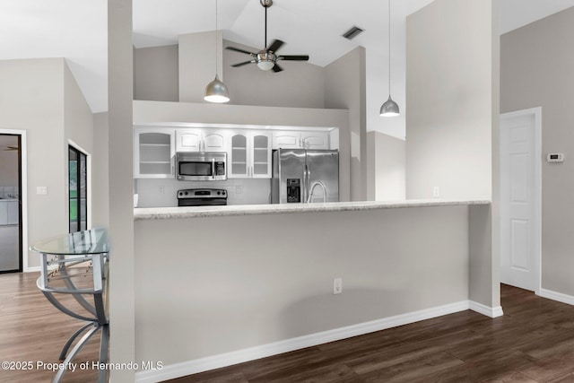 13125 Jessica Dr, Spring Hill, FL 34609 - kitchen featuring appliances with stainless steel finishes, high vaulted ceiling, glass insert cabinets, a peninsula, and white cabinets