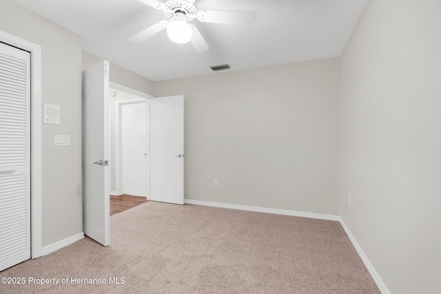 13125 Jessica Dr, Spring Hill, FL 34609 - unfurnished bedroom with carpet flooring, a ceiling fan, and a closet