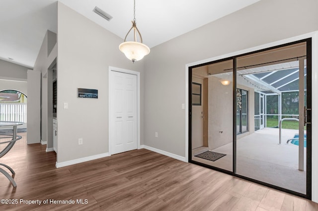 13125 Jessica Dr, Spring Hill, FL 34609 - unfurnished dining area featuring lofted ceiling, wood finished floors, and a sunroom