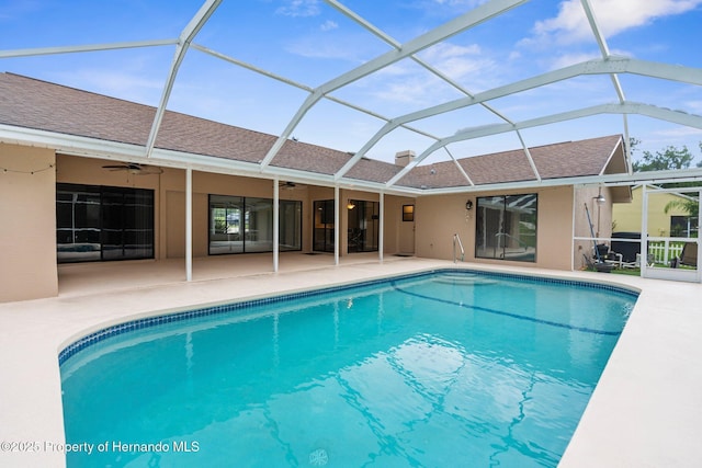 13125 Jessica Dr, Spring Hill, FL 34609 - outdoor pool featuring a ceiling fan, a patio, and glass enclosure