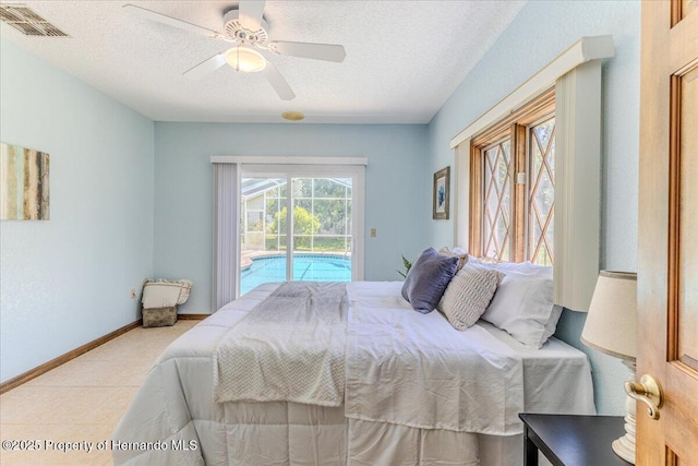4276 River Birch Dr, Spring Hill, FL 34607 - bedroom featuring access to outside, a textured ceiling, and a ceiling fan