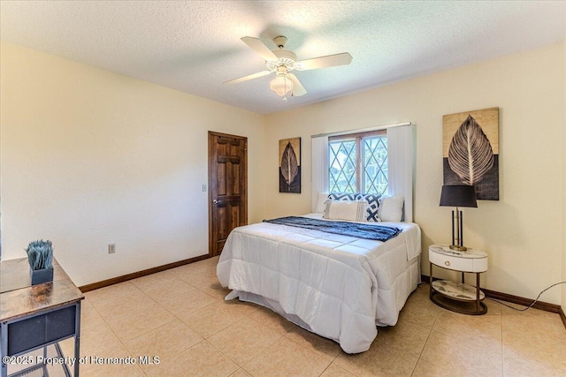 4276 River Birch Dr, Spring Hill, FL 34607 - bedroom featuring light tile patterned flooring, a textured ceiling, and ceiling fan