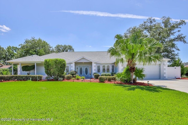 4276 River Birch Dr, Spring Hill, FL 34607 - ranch-style home with concrete driveway, a front lawn, and a garage