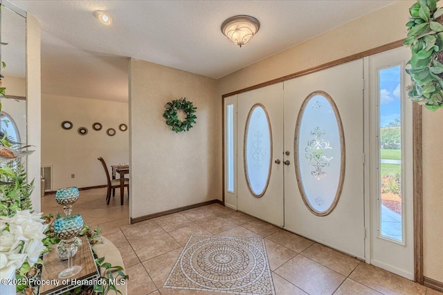 4276 River Birch Dr, Spring Hill, FL 34607 - entryway featuring healthy amount of natural light, light tile patterned floors, and french doors