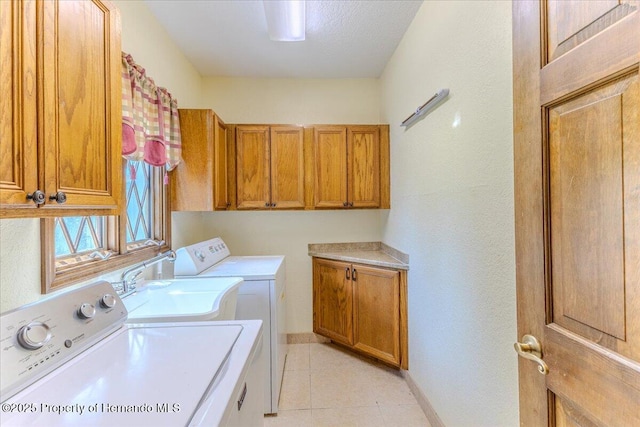 4276 River Birch Dr, Spring Hill, FL 34607 - washroom featuring washer and dryer, cabinet space, and light tile patterned floors