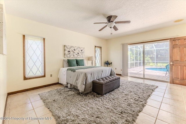 4276 River Birch Dr, Spring Hill, FL 34607 - bedroom with access to exterior, light tile patterned floors, a textured ceiling, and ceiling fan