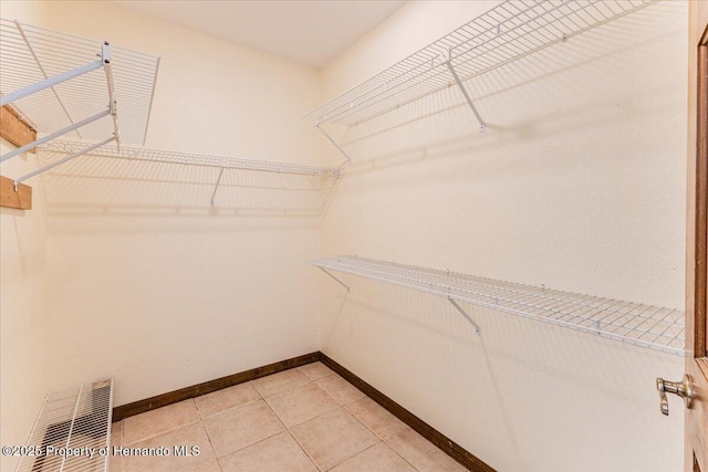 4276 River Birch Dr, Spring Hill, FL 34607 - walk in closet with light tile patterned flooring