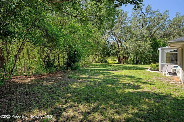 8410 Lakehill Ct, Spring Hill, FL 34608 - view of green lawn featuring a sunroom