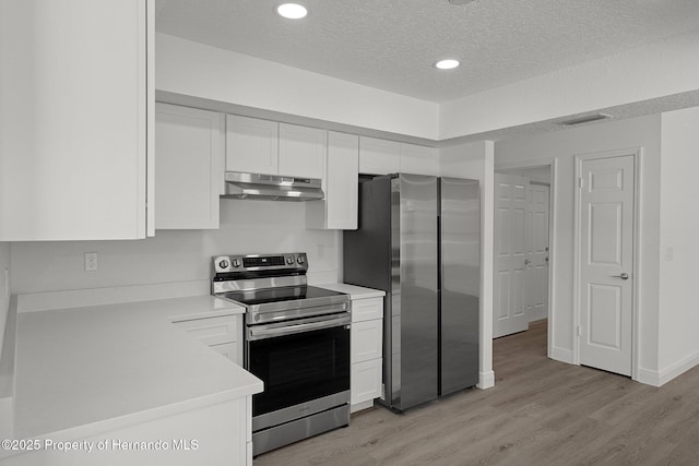 8410 Lakehill Ct, Spring Hill, FL 34608 - kitchen with appliances with stainless steel finishes, under cabinet range hood, white cabinets, light countertops, and light wood-style flooring