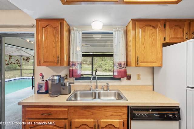 13345 Convent Garden Rd, Brooksville, FL 34613 - kitchen featuring white appliances, light countertops, plenty of natural light, and brown cabinetry