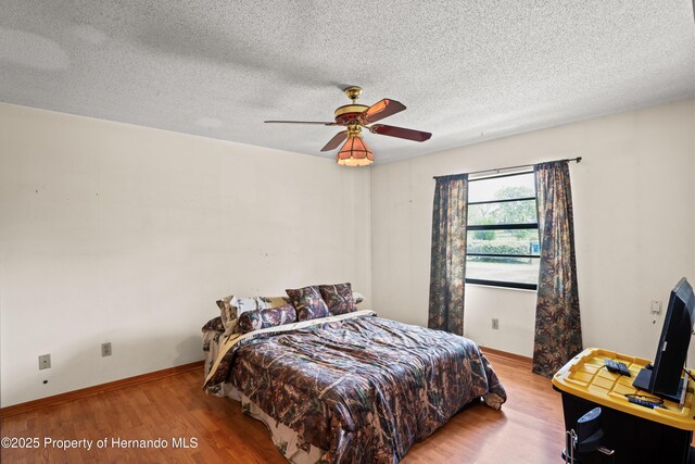13345 Convent Garden Rd, Brooksville, FL 34613 - bedroom with wood finished floors, a textured ceiling, and ceiling fan
