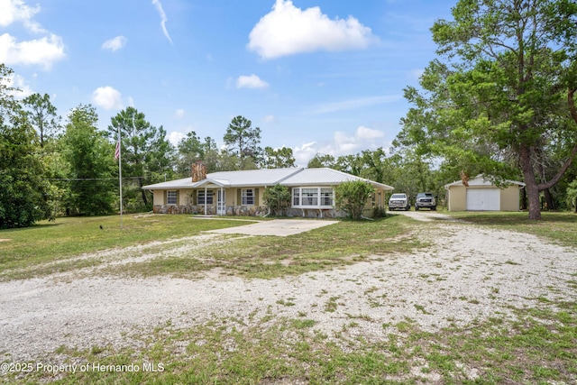 13345 Convent Garden Rd, Brooksville, FL 34613 - ranch-style home with a chimney, an outbuilding, a front yard, and driveway