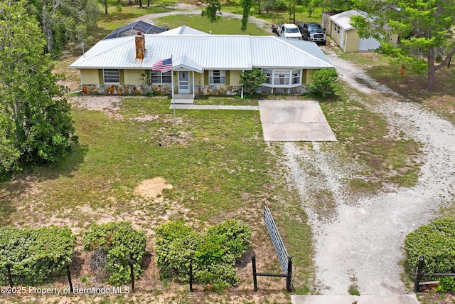 13345 Convent Garden Rd, Brooksville, FL 34613 - view of front of home with driveway, a metal roof, a front yard, and covered porch