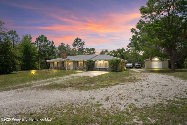 13345 Convent Garden Rd, Brooksville, FL 34613 - single story home with a chimney, an outdoor structure, gravel driveway, and a lawn