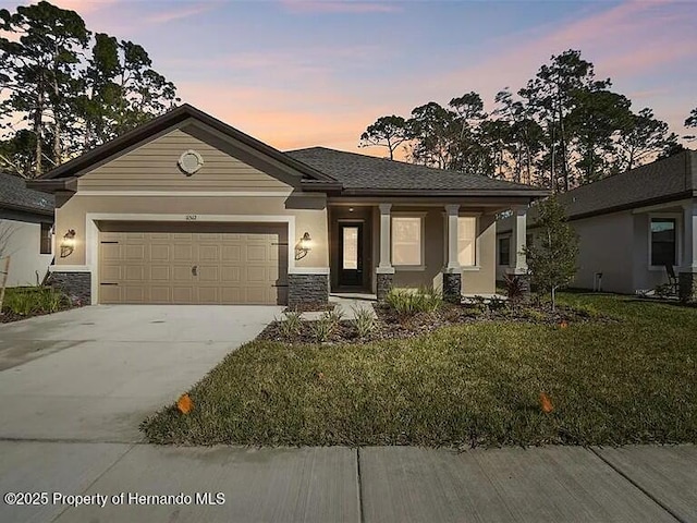 11512 Weaver Hollow Rd, New Port Richey, FL 34654 - view of front of house featuring stone siding, driveway, an attached garage, and a front yard