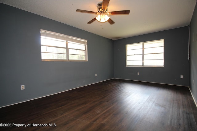 6275 Casson St, Brooksville, FL 34604 - spare room featuring plenty of natural light, dark wood-style flooring, and ceiling fan