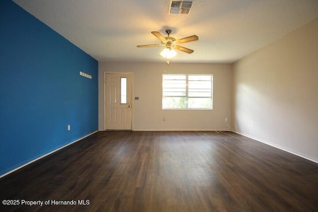 6275 Casson St, Brooksville, FL 34604 - empty room with ceiling fan and dark wood finished floors