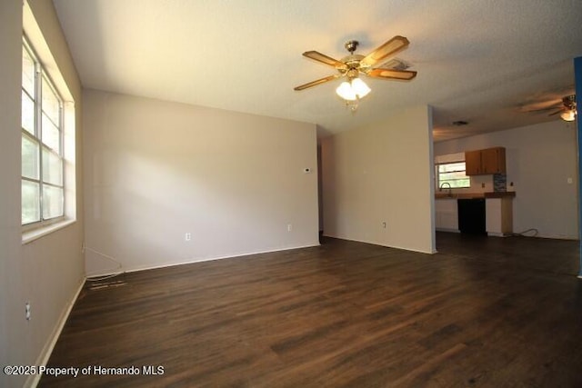 6275 Casson St, Brooksville, FL 34604 - unfurnished living room featuring ceiling fan and dark wood-style flooring
