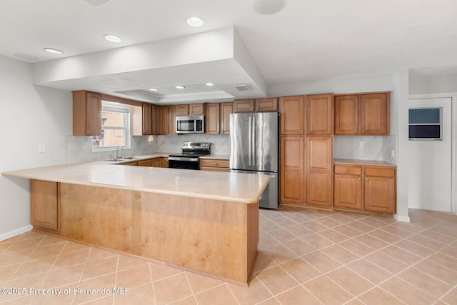 4299 Bellaire Dr, Hernando Beach, FL 34607 - kitchen featuring stainless steel appliances, light countertops, a peninsula, decorative backsplash, and recessed lighting