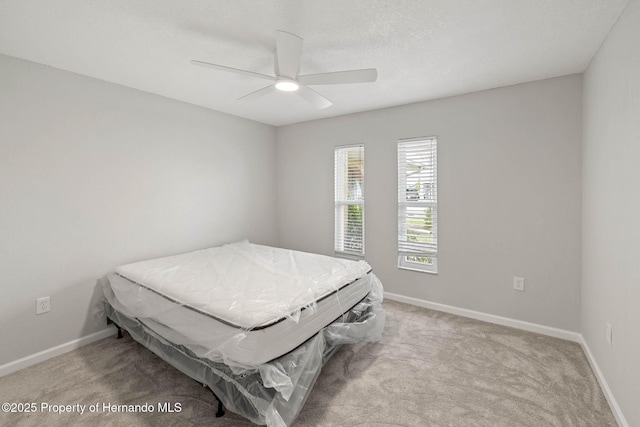 4299 Bellaire Dr, Hernando Beach, FL 34607 - carpeted bedroom with baseboards and a ceiling fan